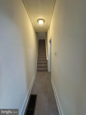 a view of a hallway with stairs