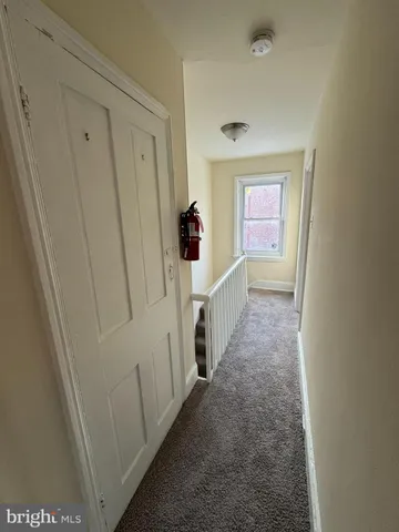 a view of a hallway with white walls