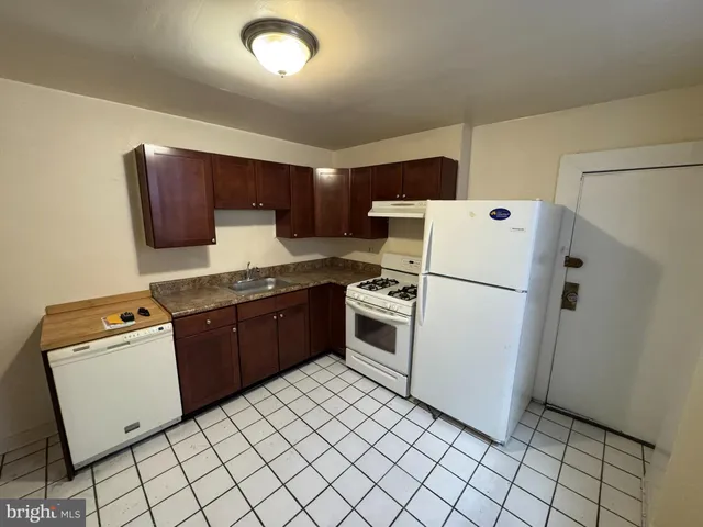 a kitchen with a refrigerator sink stove and cabinets