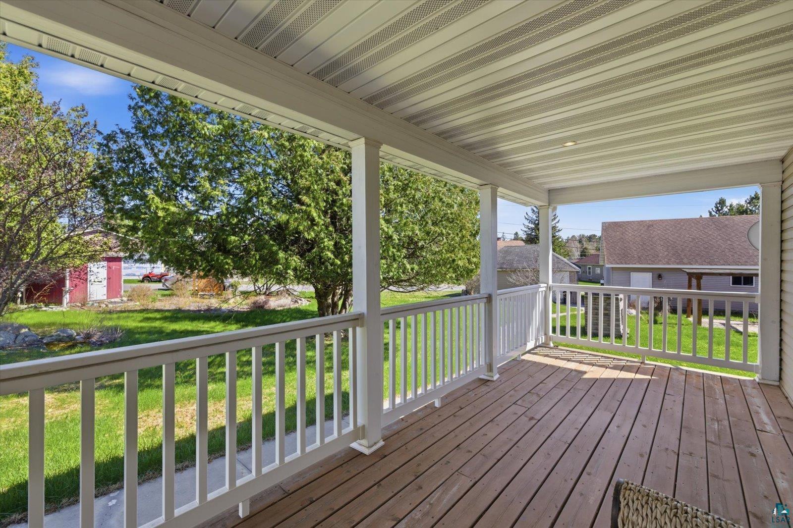 50 Main Street Soudan, MN 55782 - Photo 12 of 31 Covered outdoor porch featuring wood-finish flooring, white railing, and a white paneled ceiling