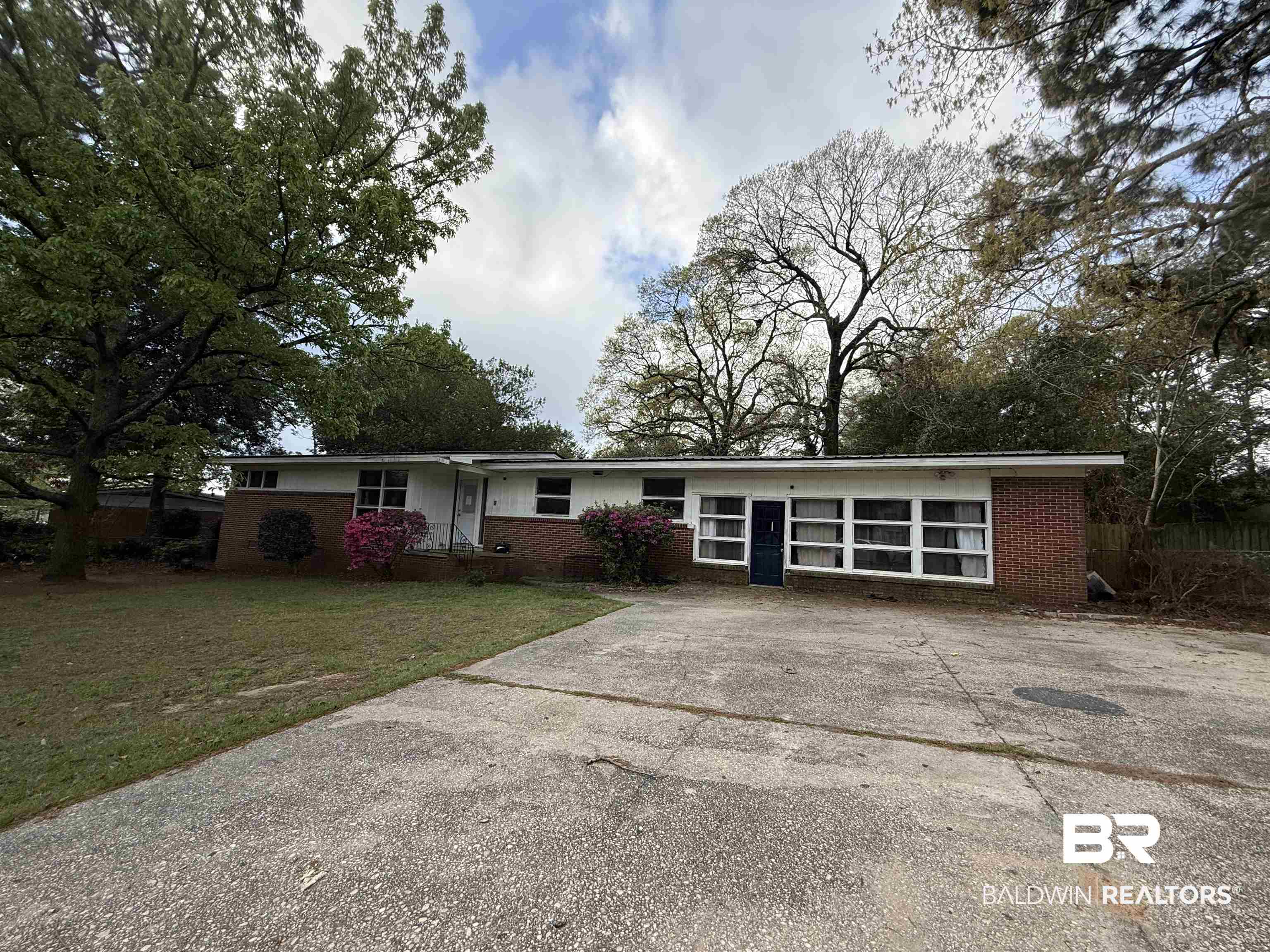 4003 Michael Boulevard Mobile, AL 36609 - Photo 1 of 2 Ranch-style home featuring brick siding, a front lawn, and driveway
