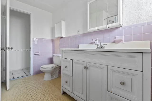 a bathroom with a sink a toilet and vanity