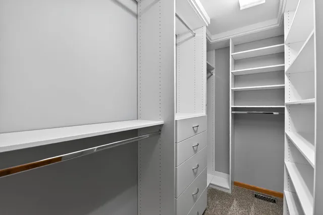 a room with white cabinets and a window