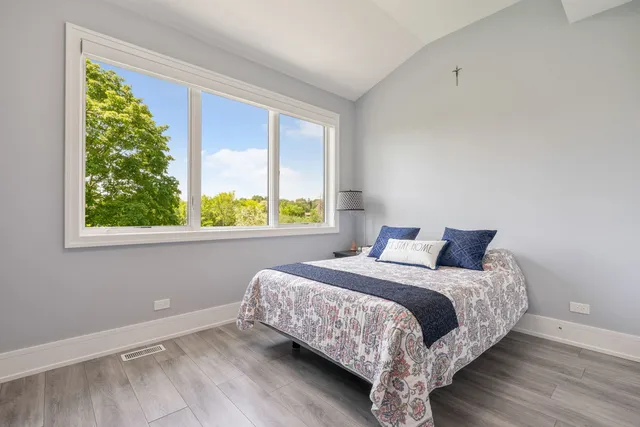 a bedroom with a bed and a table in it