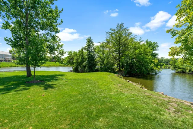 an aerial view of a house next to a big yard