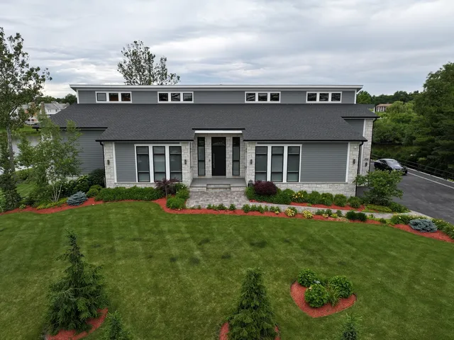 a view of a house with a yard and plants