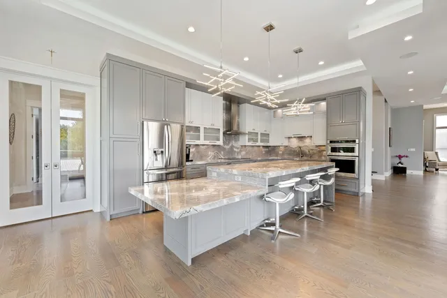 a large kitchen with stainless steel appliances lots of counter space and breakfast area