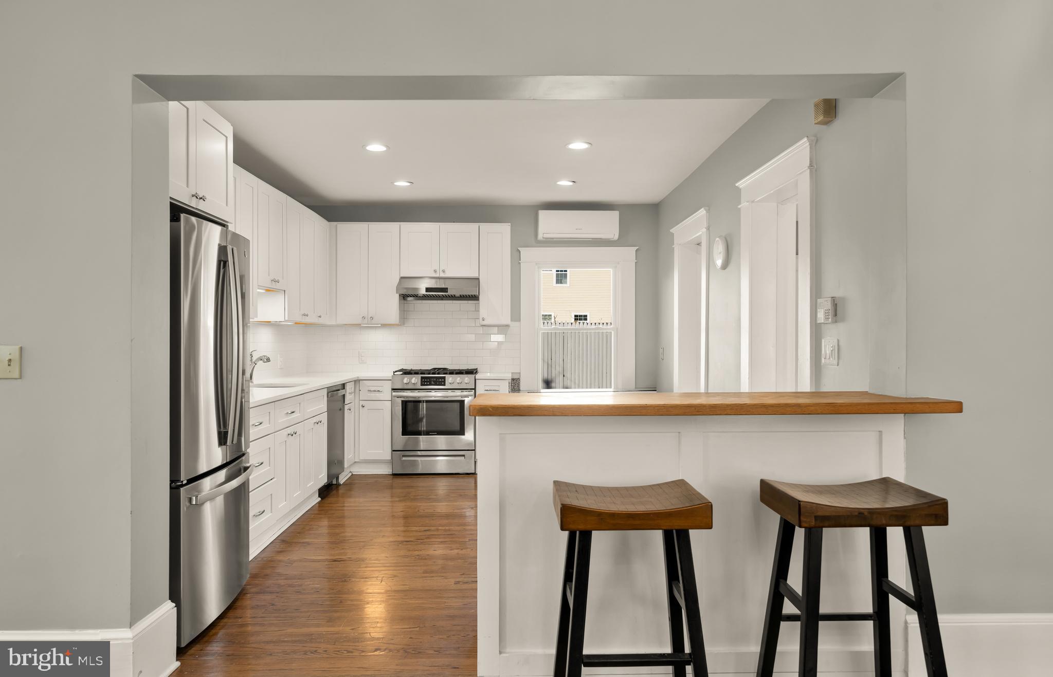 1308 Lawrence Street Northeast Washington, DC 20017 - Photo 14 of 43 a kitchen with white cabinets and stainless steel appliances