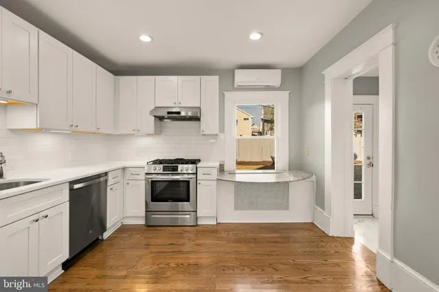 a kitchen with stainless steel appliances granite countertop a stove and a sink