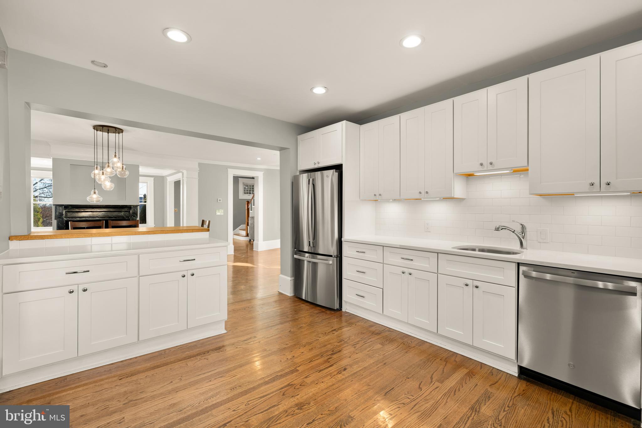 1308 Lawrence Street Northeast Washington, DC 20017 - Photo 18 of 43 a kitchen with stainless steel appliances granite countertop a refrigerator sink and white cabinets
