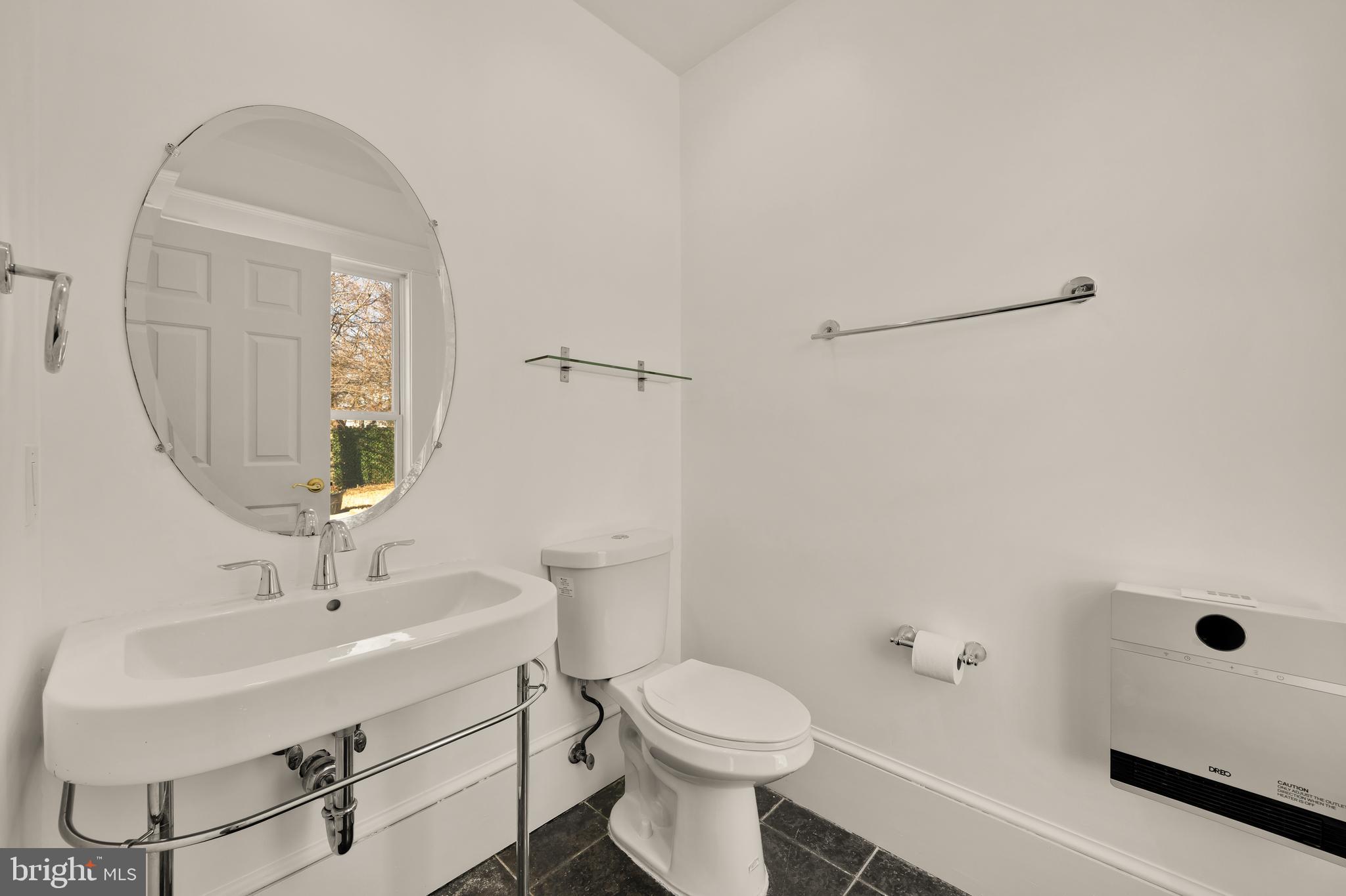 1308 Lawrence Street Northeast Washington, DC 20017 - Photo 19 of 43 a bathroom with a sink a toilet and shower