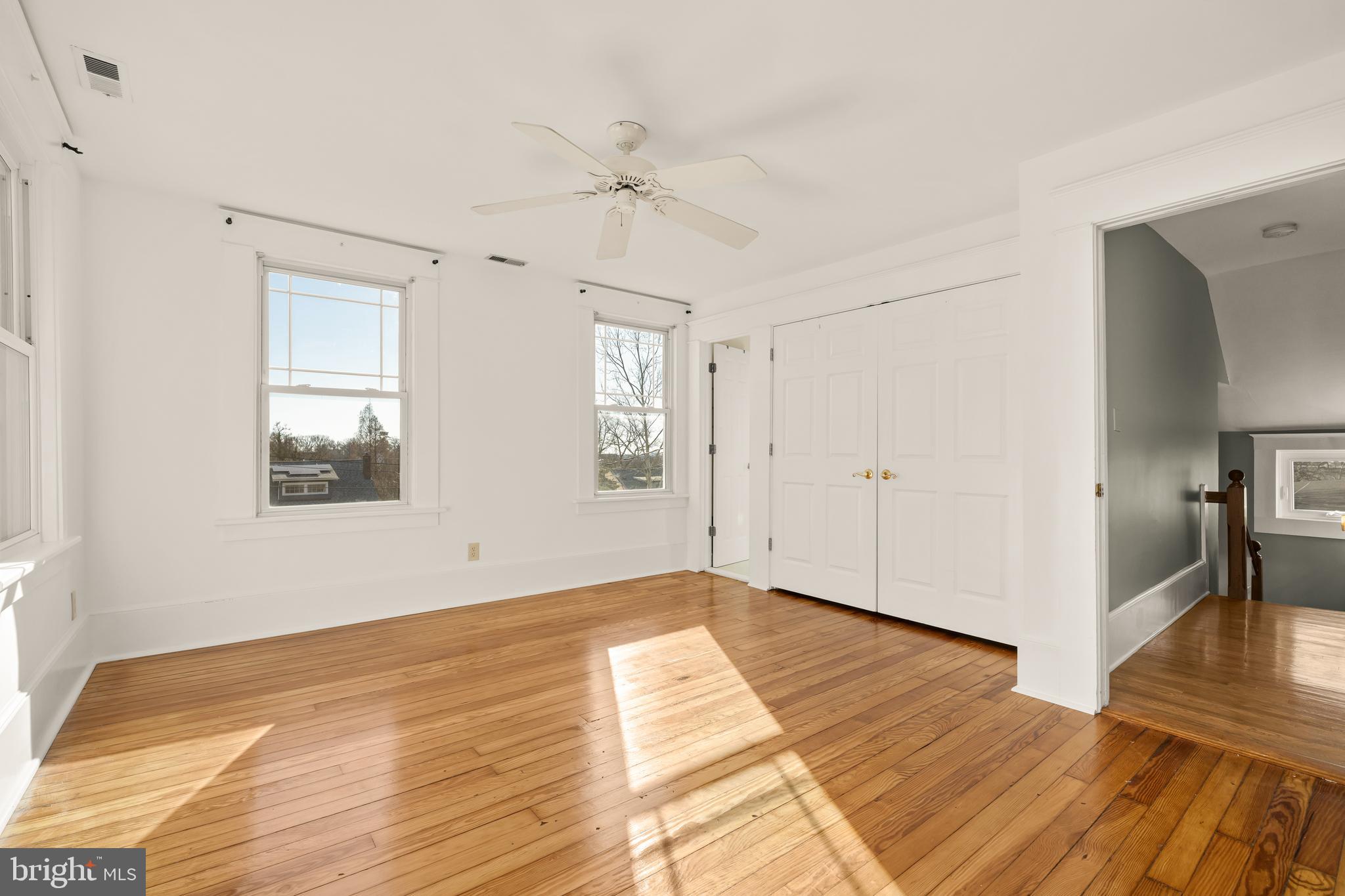 1308 Lawrence Street Northeast Washington, DC 20017 - Photo 26 of 43 a view of an empty room with wooden floor and a window