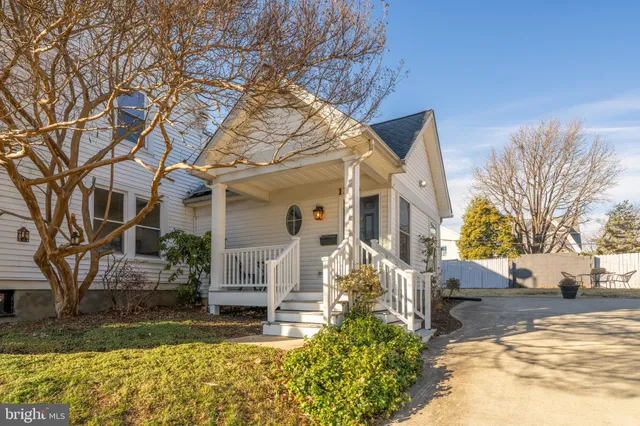 a view of a house with a yard covered in snow