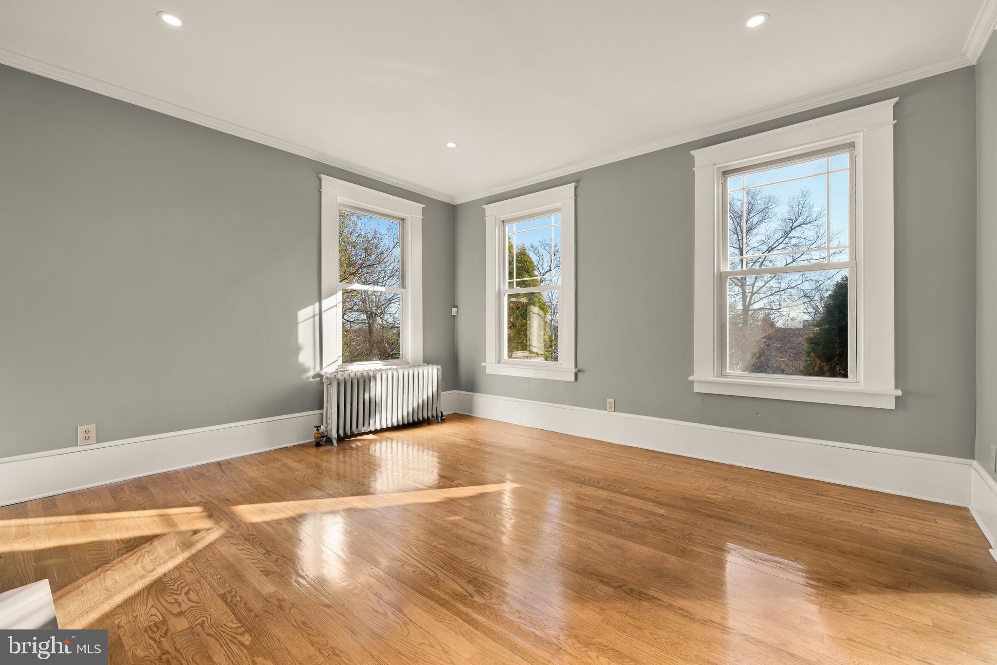 1308 Lawrence Street Northeast Washington, DC 20017 - Photo 9 of 43 a view of an empty room with a window and wooden floor