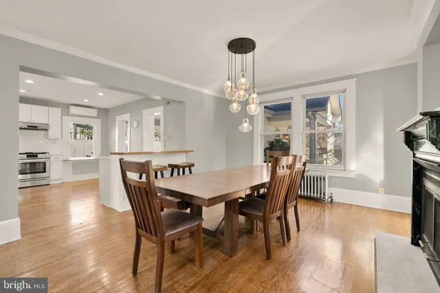 a view of a dining room with furniture wooden floor and chandelier