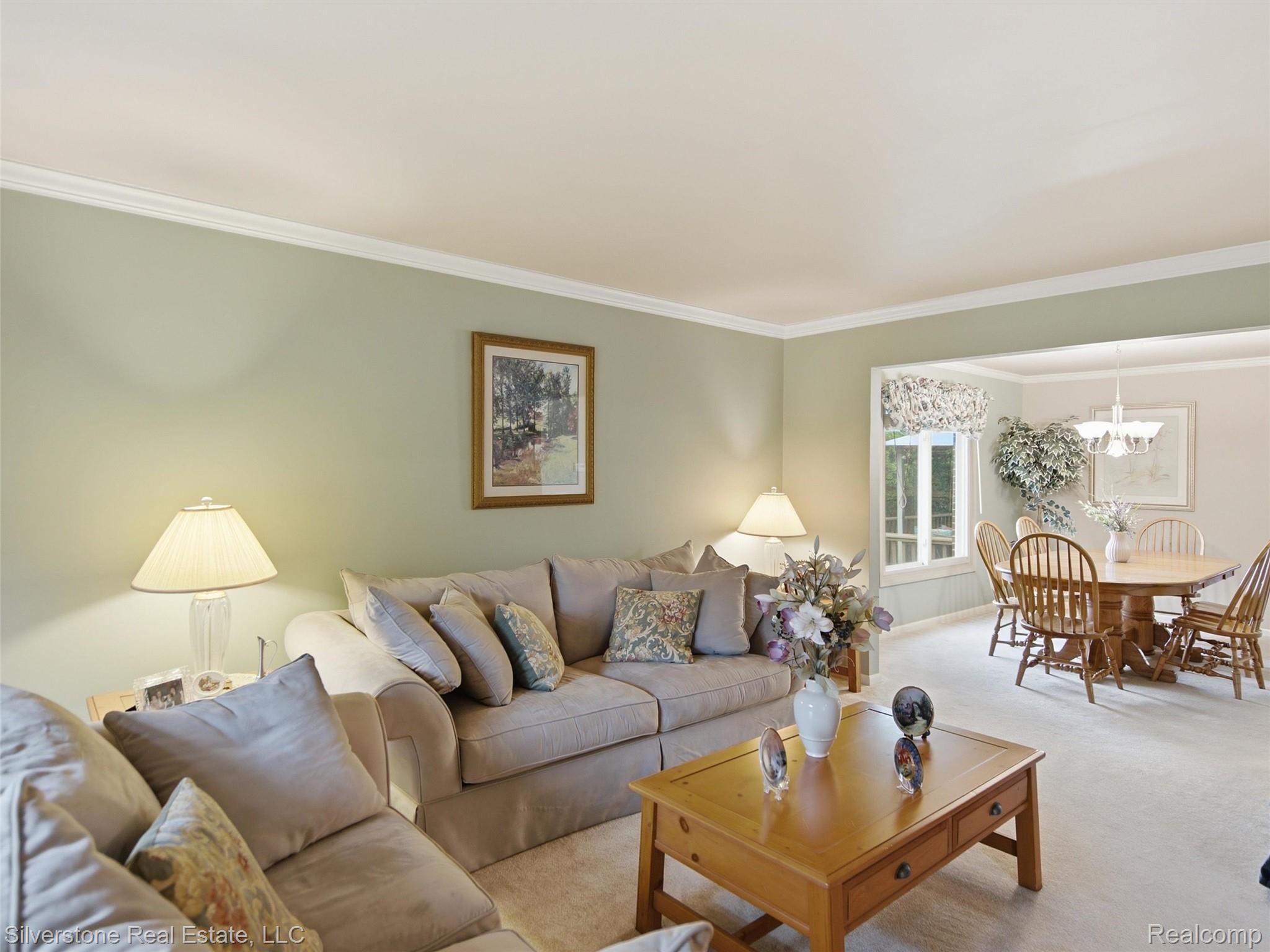 6577 Edith Court Troy, MI 48085 - Photo 18 of 61 Living area with light green walls and white crown molding