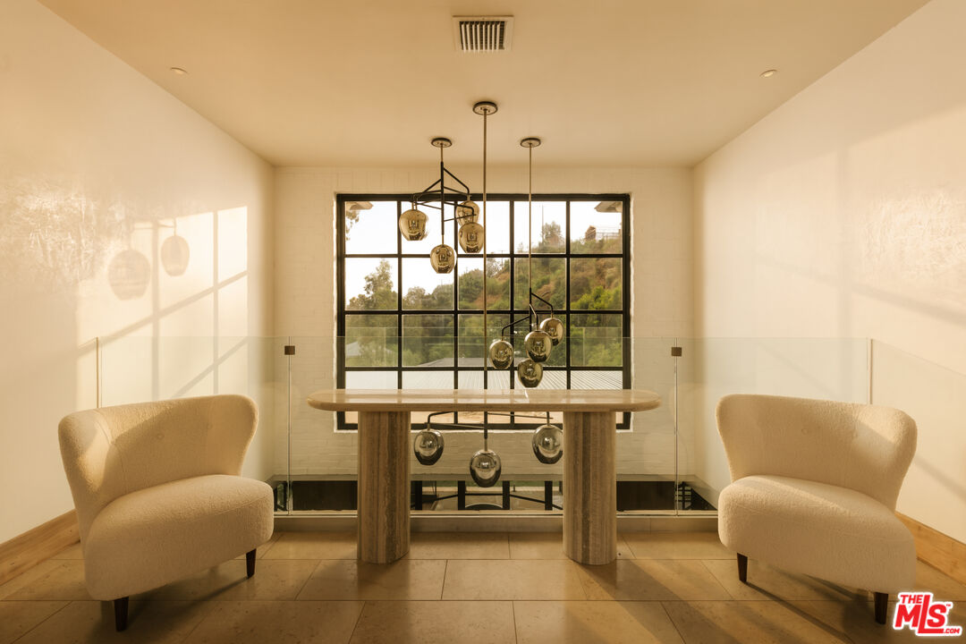 1105 Rivas Canyon Road Pacific Palisades, CA 90272 - Photo 11 of 49 a living room with furniture and a large window