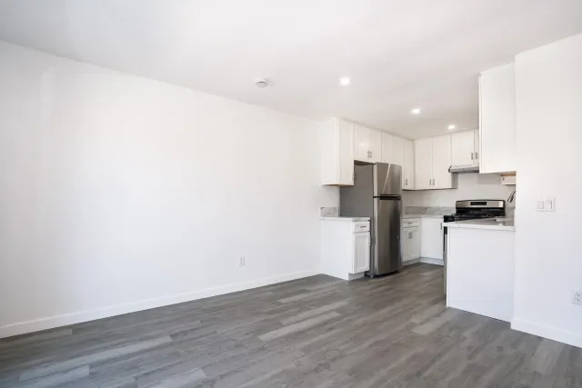 a kitchen with stainless steel appliances a refrigerator and a stove top oven