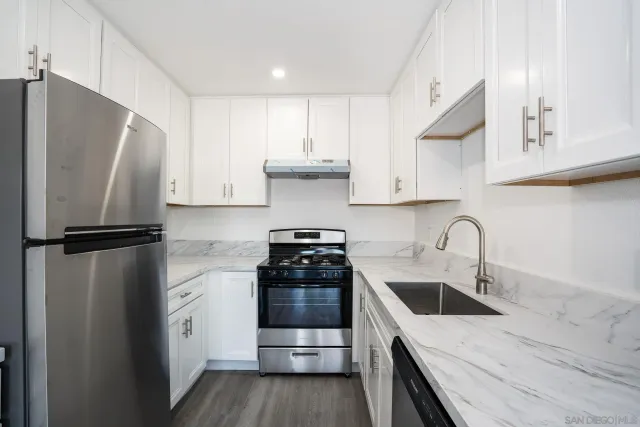 a kitchen with a refrigerator sink and stove