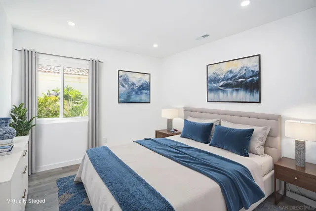 a bedroom with a large bed and a potted plant