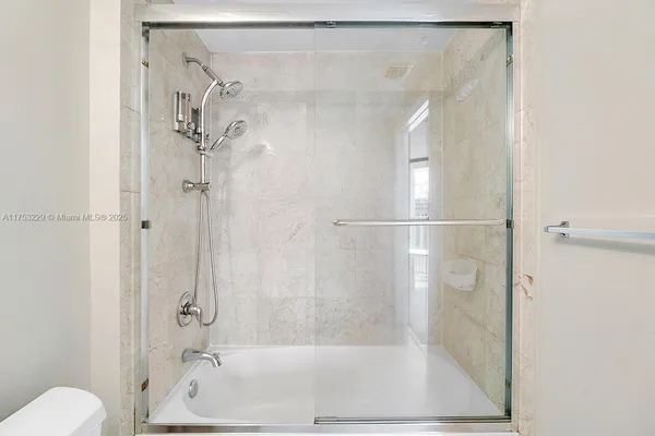 a bathroom with a shower and a toilet