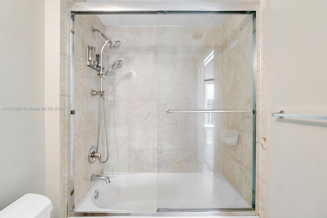 9066 Southwest 73rd Court, Unit 1904 Miami, FL 33156 - Photo 7 of 19 a bathroom with a shower and a toilet