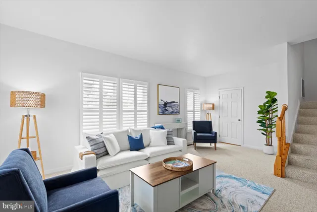 a kitchen with stainless steel appliances granite countertop a refrigerator a stove a sink and a dining table with chairs