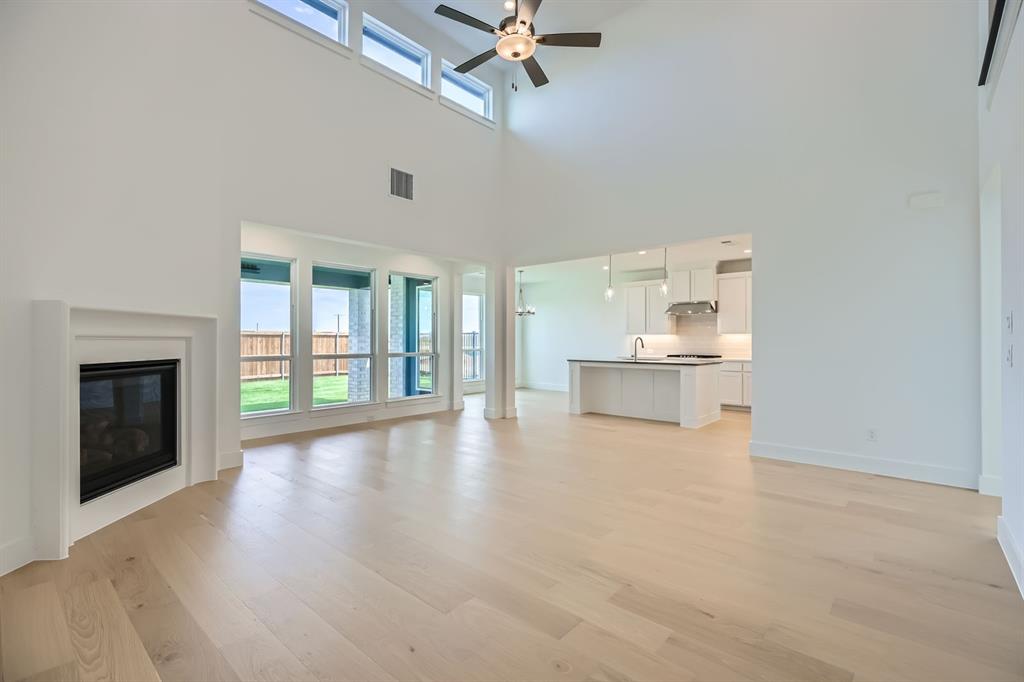 2620 Cedar Rdg Road Celina, TX 75009 - Photo 3 of 27 a view of an empty room with a kitchen and a window
