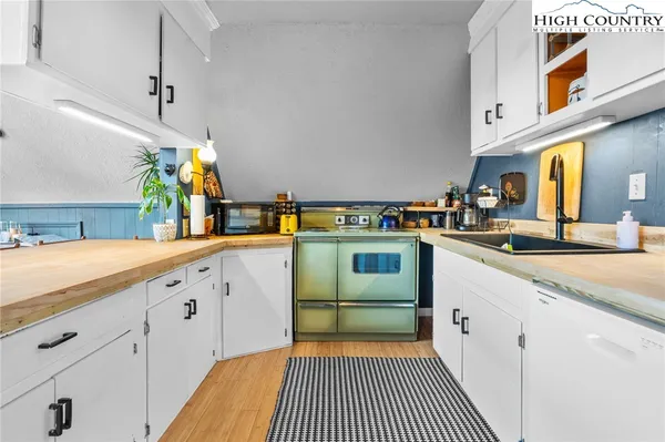 a kitchen with cabinets a sink and appliances