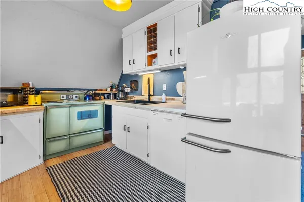 a kitchen with a cabinets and white appliances