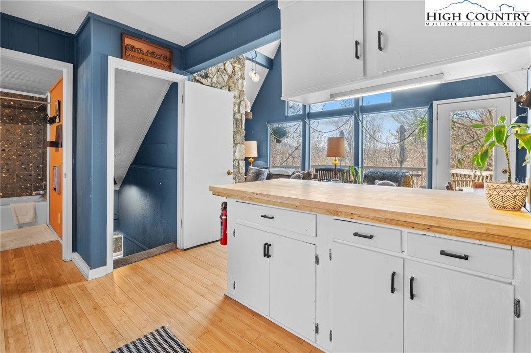 179 Rhododendron Drive Beech Mountain, NC 28604 - Photo 13 of 44 a bathroom with a sink and mirror with bathtub