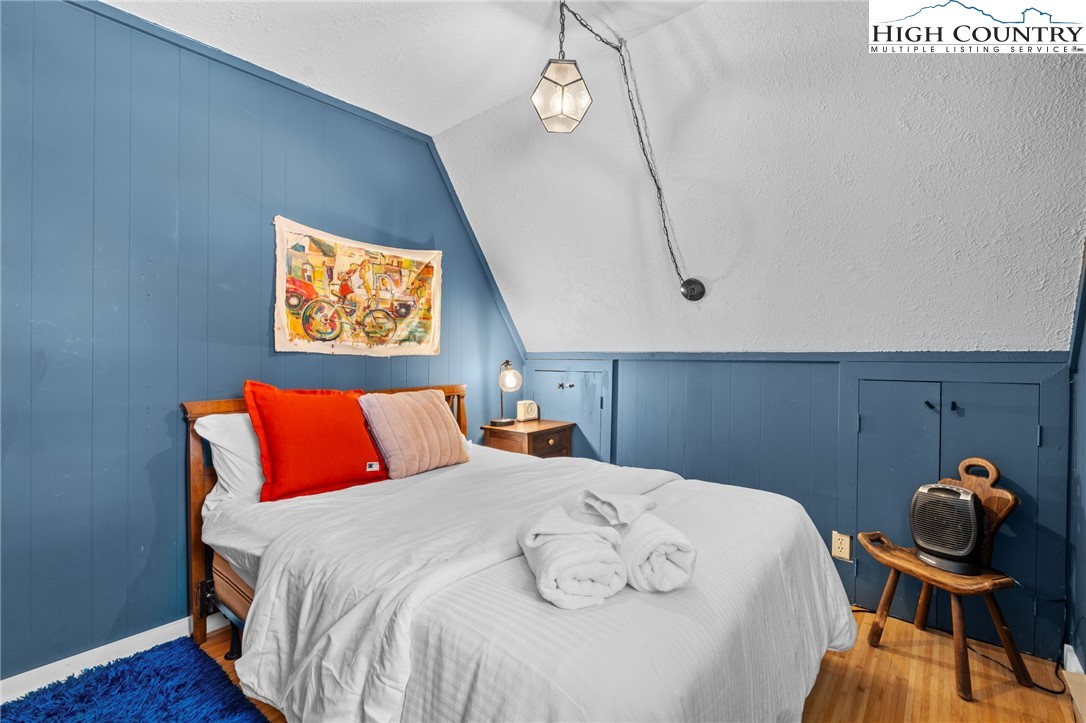 179 Rhododendron Drive Beech Mountain, NC 28604 - Photo 16 of 44 a bedroom with a bed and wooden floor