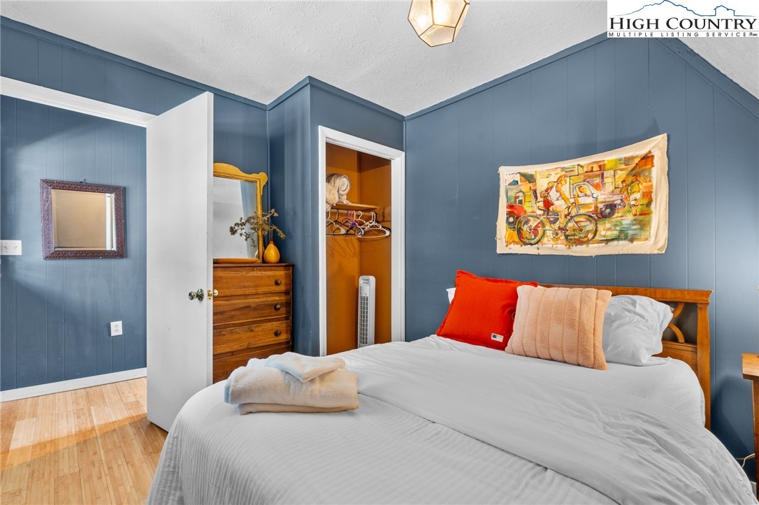 179 Rhododendron Drive Beech Mountain, NC 28604 - Photo 17 of 44 a bedroom with a bed and a painting on the wall