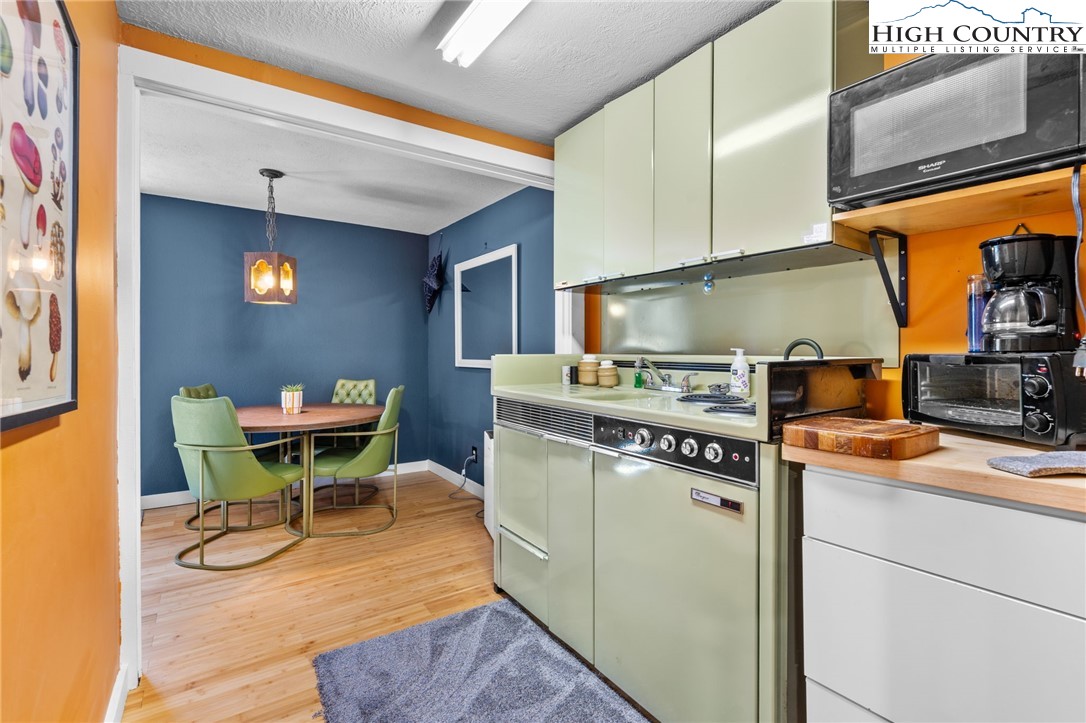 179 Rhododendron Drive Beech Mountain, NC 28604 - Photo 23 of 44 a kitchen with a stove and cabinets