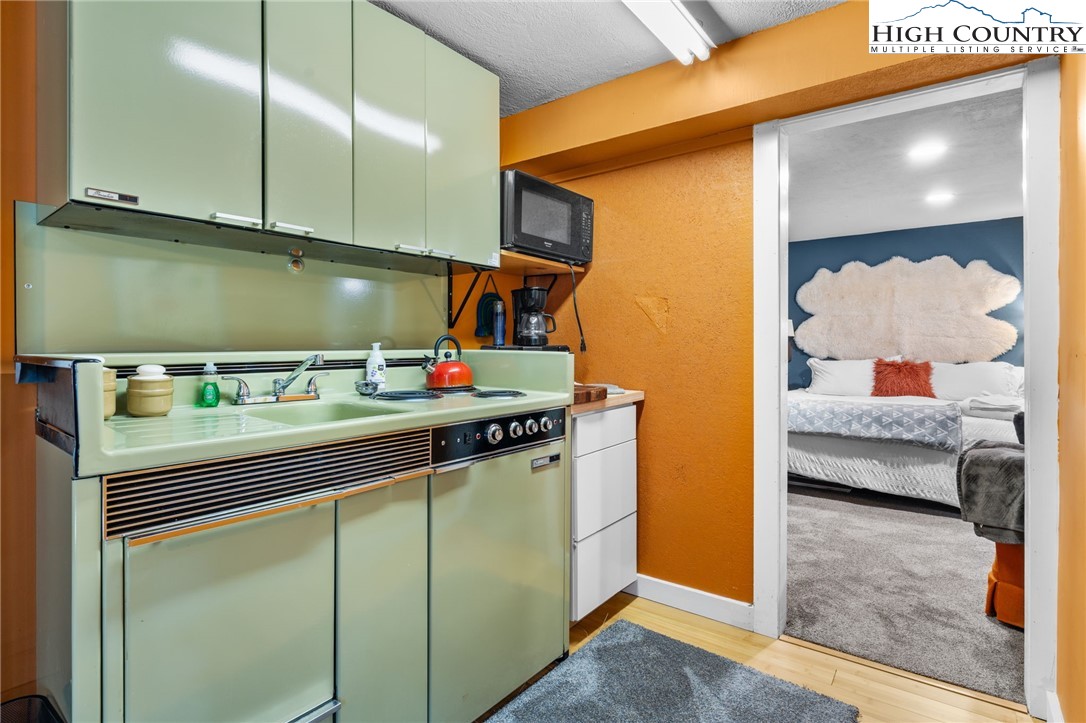 179 Rhododendron Drive Beech Mountain, NC 28604 - Photo 24 of 44 a kitchen with stainless steel appliances granite countertop a sink and cabinets