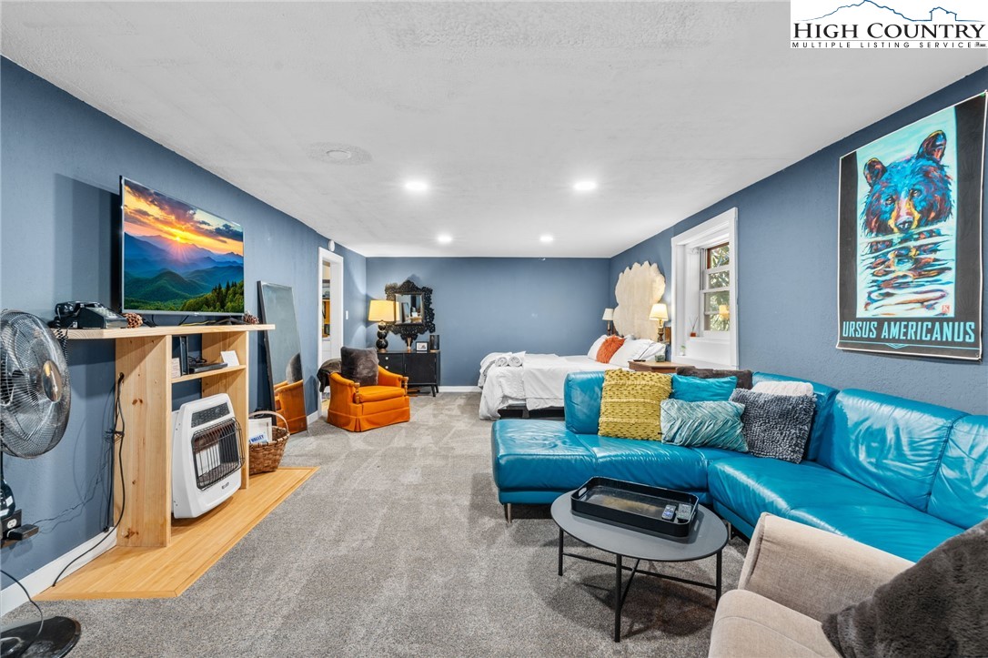 179 Rhododendron Drive Beech Mountain, NC 28604 - Photo 28 of 44 a living room with furniture and a flat screen tv