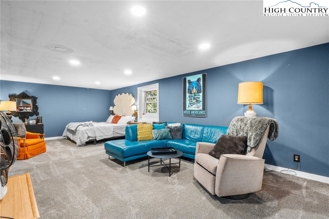 179 Rhododendron Drive Beech Mountain, NC 28604 - Photo 29 of 44 a living room with furniture a window and a lamp