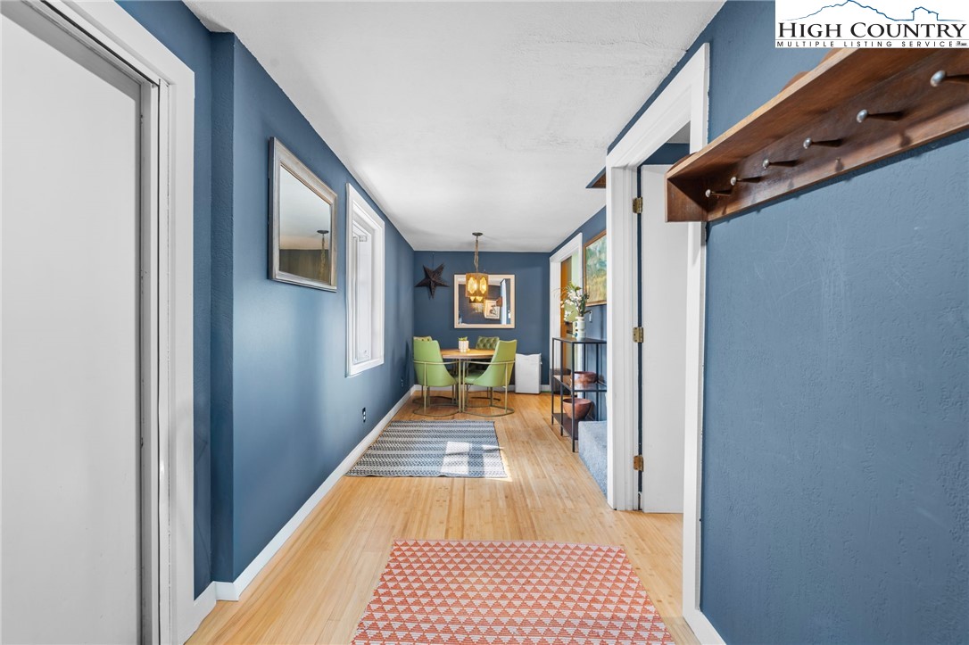 179 Rhododendron Drive Beech Mountain, NC 28604 - Photo 30 of 44 a view of a hallway with wooden floor and staircase