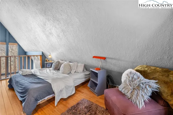 a bedroom with a bed and a book shelf