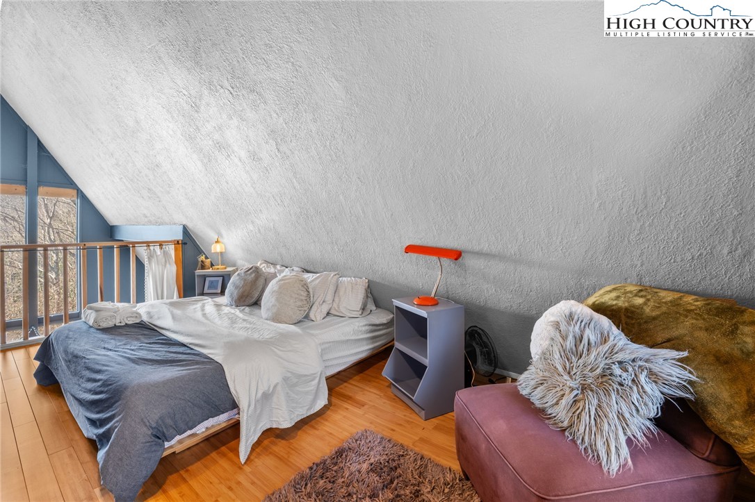 179 Rhododendron Drive Beech Mountain, NC 28604 - Photo 33 of 44 a bedroom with a bed and a book shelf