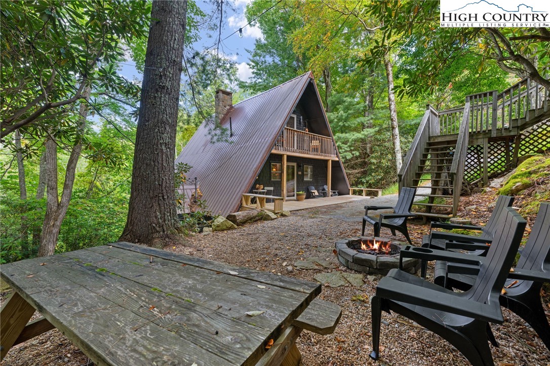 179 Rhododendron Drive Beech Mountain, NC 28604 - Photo 40 of 44 a view of a patio with table and chairs and wooden floor