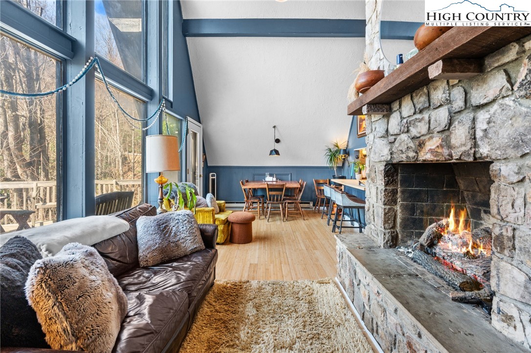 179 Rhododendron Drive Beech Mountain, NC 28604 - Photo 4 of 44 a living room with furniture fireplace and a large window
