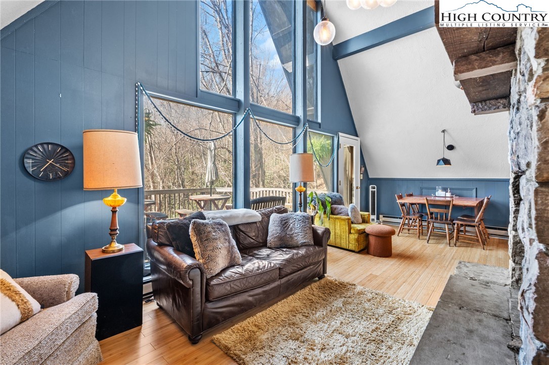179 Rhododendron Drive Beech Mountain, NC 28604 - Photo 7 of 44 a living room with furniture and a floor to ceiling window