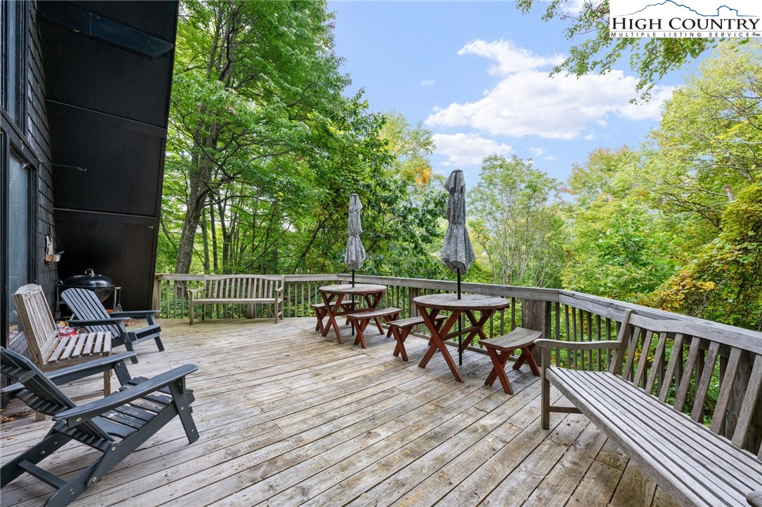 179 Rhododendron Drive Beech Mountain, NC 28604 - Photo 8 of 44 a view of a chairs and table on the wooden floor