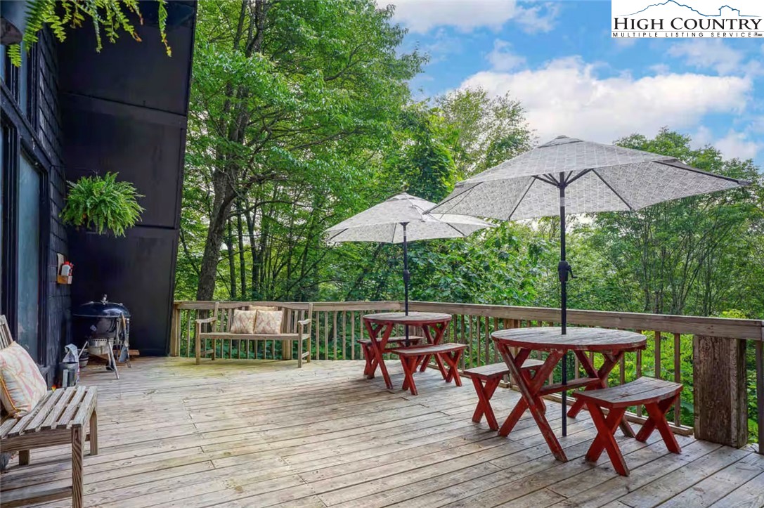179 Rhododendron Drive Beech Mountain, NC 28604 - Photo 9 of 44 an outdoor space with furniture and umbrella