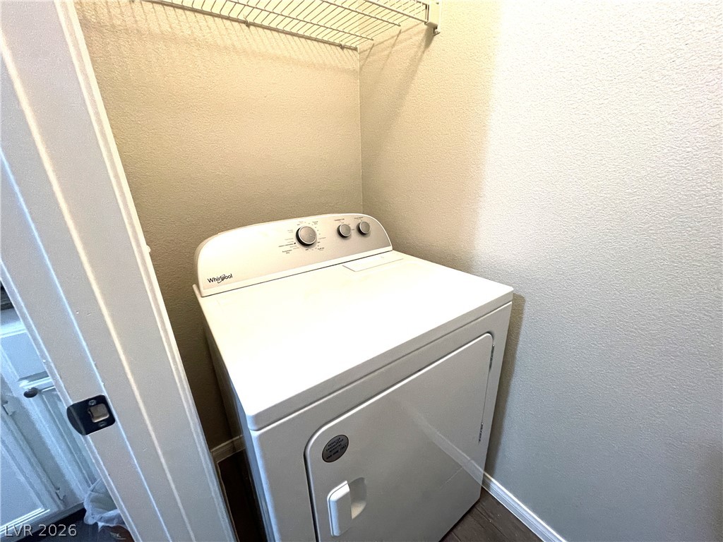 10001 Peace Way, Unit 1327 Las Vegas, NV 89147 - Photo 12 of 21 A dedicated laundry closet with a modern dryer ensures efficient utility space.