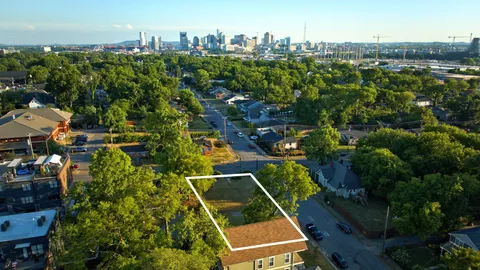 an aerial view of multiple houses with yard
