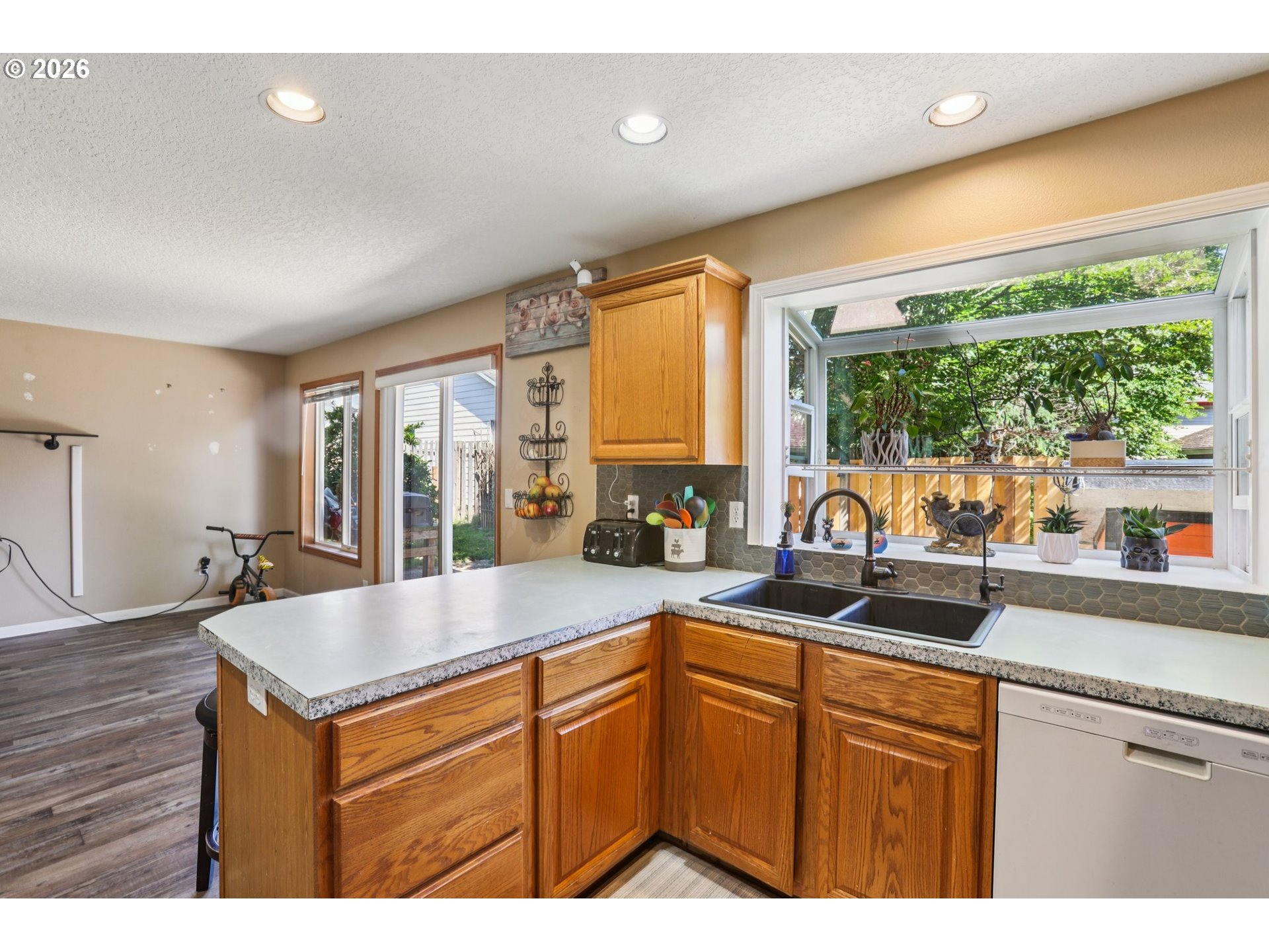 4055 Northeast 13th Terrace Gresham, OR 97030 - Photo 14 of 37 a kitchen with granite countertop a sink and a cabinets