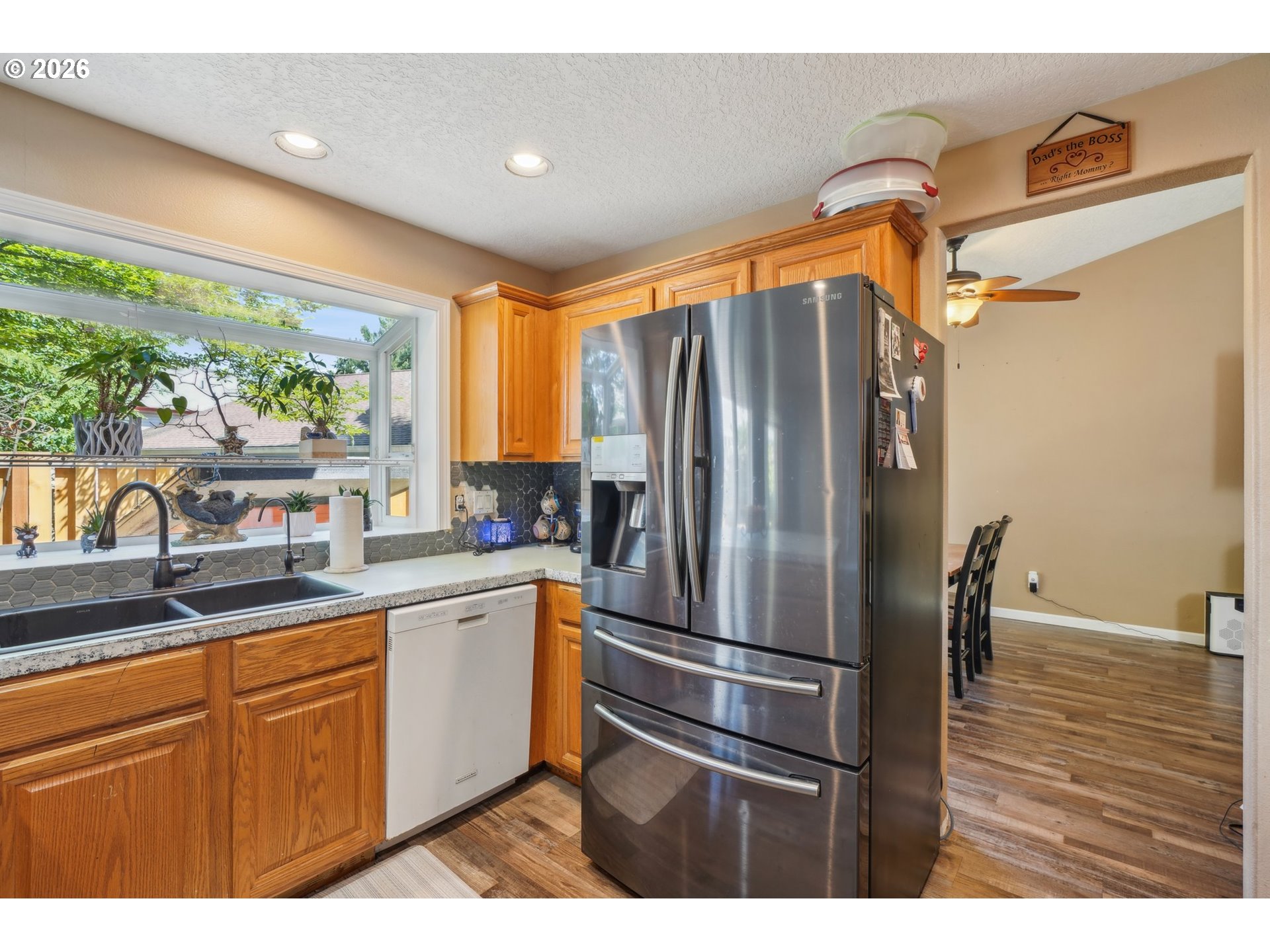 4055 Northeast 13th Terrace Gresham, OR 97030 - Photo 16 of 37 a kitchen with stainless steel appliances a refrigerator sink and cabinets