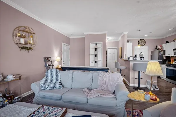 a living room with furniture and wooden floor